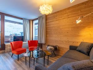 a living room with a couch and red chairs at Apartment Le Pramecou - Val Claret-8 by Interhome in Tignes