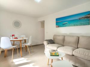 a living room with a couch and a table at Apartment Clara B - CSV177 by Interhome in Cala de Sant Vicenc