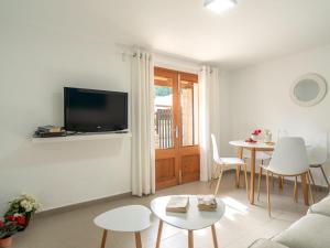 a living room with a couch and a table at Apartment Clara B - CSV177 by Interhome in Cala de Sant Vicenc