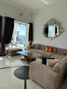 a living room with a couch and a table at Riad Ras Lafaa in Safi