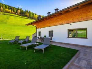 a group of chairs sitting on a lawn at Holiday Home Spieglhof-4 by Interhome in Sarntal