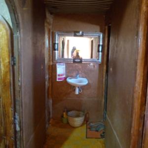 a small bathroom with a sink and a mirror at Camp Mbark authentic in Mhamid