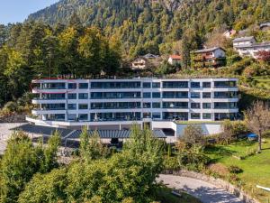 un bâtiment de bureau sur une colline plantée d'arbres dans l'établissement Apartment Adlerblick alpe maritima Ski & See - 22 by Interhome, à Annenheim