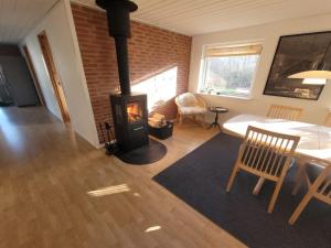 a living room with a wood stove in a room at Holiday Home Geske - all inclusive - 3-2km from the sea in Sealand by Interhome in Eskebjerg
