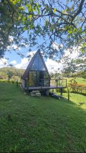 a small house in the middle of a field at Chalet Llano Grande in Rionegro