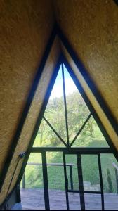 a large window in a room with a wooden floor at Chalet Llano Grande in Rionegro