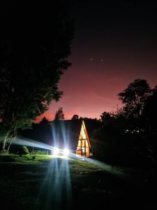 a barn lit up at night with lights at Chalet Llano Grande in Rionegro