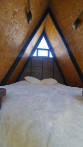 a large bed in a room with a window at Chalet Llano Grande in Rionegro