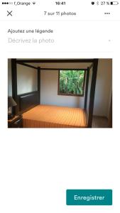 a bed in a room with a window at Maison Nature in Le Moule
