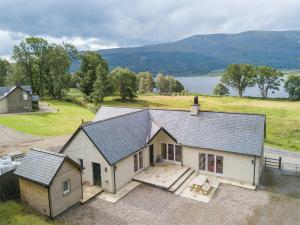 an aerial view of a house with a lake in the background at 3 Bed in Achnacarry CA018 