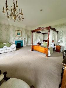 a bedroom with two beds and a chandelier at Solberge Hall in Northallerton