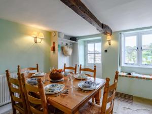 a dining room with a wooden table and chairs at 3 Bed in Isle of Purbeck IC027 in Kingston