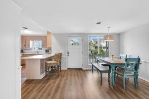 a kitchen and dining room with a table and chairs at Isle Of A Time Brunswick Vacation Rentals Canal front with Boat slip in Ocean Isle Beach