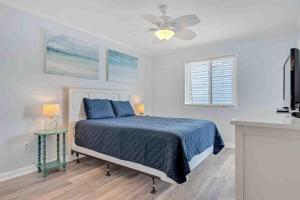 a bedroom with a bed and a ceiling fan at I'll Be There For You in Ocean Isle Beach +46 photos