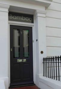a black door on the side of a building at Bamboo Guesthouse in Bournemouth