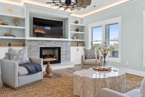 a living room with a fireplace and a tv at Havana in Ocean Isle Beach
