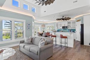 a living room with a couch and a kitchen at Havana in Ocean Isle Beach