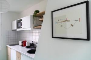 a picture hanging on a wall in a kitchen at Studio - Alma in Le Havre