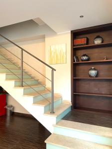 a staircase in a living room with wood floors and a stair case at Nacional B&B in Monforte San Giorgio Marina