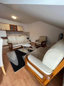 a living room with two beds and a couch at Apartman Oskar 1 in Kupres
