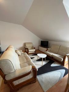 a living room with a couch and a table at Apartman Oskar 1 in Kupres