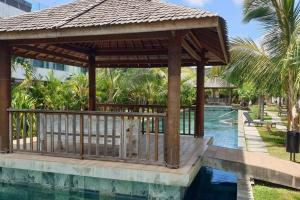 a pavilion next to a pool at a resort at Entire Appartment - Pereybere, Grand Baie in Bain Boeuf