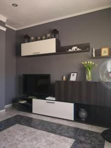 a living room with a flat screen tv on a wall at 2 bedrooms apartement with wifi at Barbastro in Barbastro