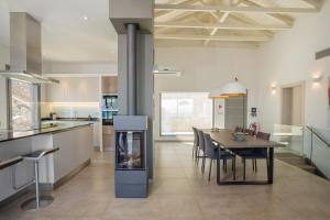a kitchen and dining room with a table and chairs at Villa Lefkas - Luxury villa Sivota with direct sea access in Sivota +24 photos