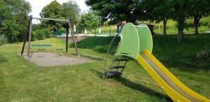 a playground with a slide in a park at Camping maeva Respire de La Croze in Châtel-Guyon