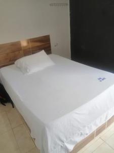 a large white bed in a room with at HOTEL LA MATA 