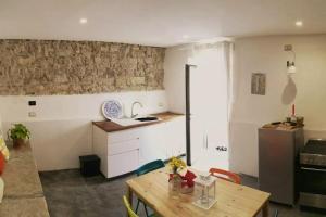 een keuken met een houten tafel en een keuken met een aanrecht bij 2 bedrooms appartement with terrace at Finocchito in Finocchito