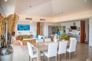 a dining room and living room with a table and chairs at Entire Appartment - Pereybere, Grand Baie in Bain Boeuf