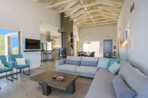 a living room with a couch and a table at Villa Lefkas - Luxury villa Sivota with direct sea access in Sivota