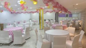 a room with tables and chairs and balloons at Zenith Mahipalpur - Free Parking in New Delhi