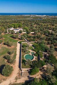 an aerial view of a resort with a river at Masseria Brigantino in Torre Canne