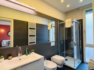 a bathroom with a sink and a toilet and a shower at AwesHomeItaly - The Little Beauty Studio in Pisa +11 photos