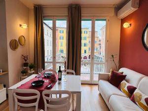 a living room with a table and a couch at AwesHomeItaly - The Little Beauty Studio in Pisa