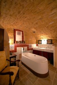 a large bathroom with a large tub and a sink at Le Clement V in Belvès