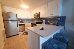 een keuken met een koelkast en een aanrecht bij Direct Oceanview Penthouse - Sleeps 6 301 in Cape Canaveral