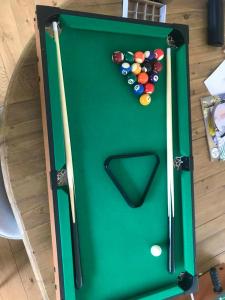 a green snooker table with balls on top of it at Maison accueillante à Bléré avec cheminée et terrasse in Bléré +23 photos