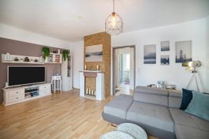 a living room with a couch and a flat screen tv at Ferienwohnung Okertalerstieg in Goslar
