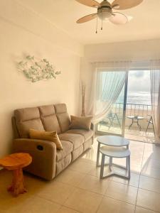 ein Wohnzimmer mit einem Sofa und einem Tisch in der Unterkunft 2 bedrooms apartement at Portimao 10 m away from the beach with wifi in Portimão