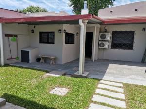 a small house with a patio and a yard at Flor de Loto in Durazno