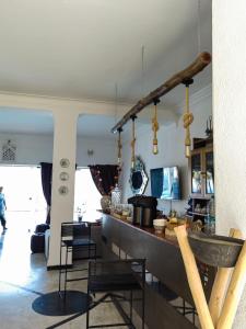 a kitchen and living room with a counter and chairs at Riad Ras Lafaa in Safi