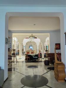 a living room with a table and some chairs at Riad Ras Lafaa in Safi