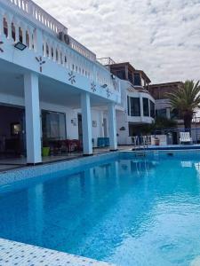 a large swimming pool in front of a building at Riad Ras Lafaa in Safi