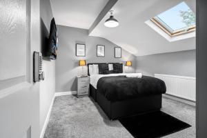 a bedroom with a bed and a skylight at Hotel comforts & home conveniences -sleeps 8 in Birmingham