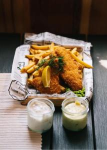 a plate of food with fried fish and french fries at Perssons i Backens Pensionat- Sjötorps Vandrarhem & Rum in Sjötorp