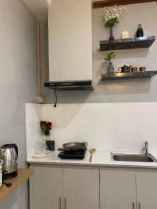 a kitchen with a sink and a counter top at Balai ni Atan - relaxing studio unit near airport in General Santos