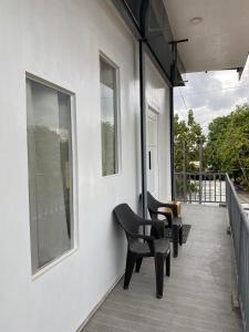 a porch with chairs on the side of a house at Balai ni Atan - relaxing studio unit near airport in General Santos